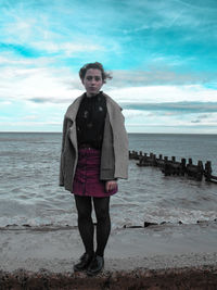 Full length portrait of man standing on beach