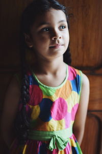 Close-up of girl standing against wall