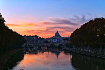 Reflection of bridge in water at sunset