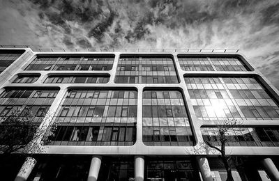 Low angle view of building against cloudy sky