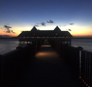 Pier on sea at sunset
