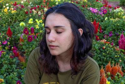 Young woman in a field of colorful wild flowers