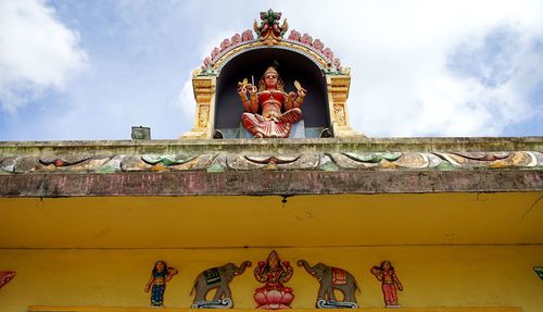 Low angle view of statue against sky