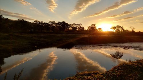 Scenic view of lake against sky during sunset