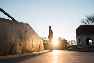 Silhouette of skateboarder in sunset