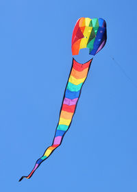 Low angle view of flag against clear blue sky