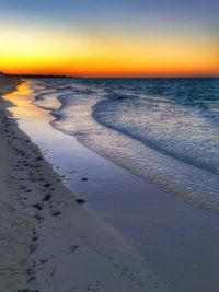 Scenic view of beach against sky during sunset