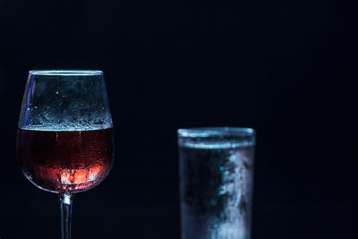 Close-up of beer glass against black background