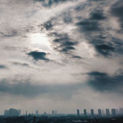 Modern buildings against cloudy sky