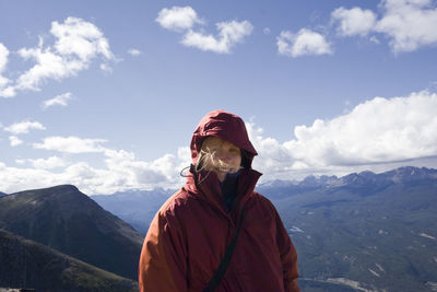 Man standing on mountain against sky