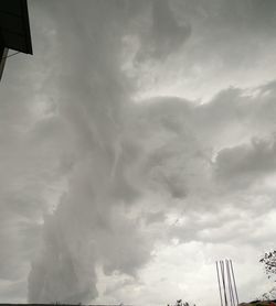 Low angle view of building against cloudy sky