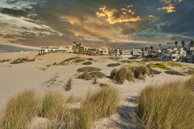 Scenic view of beach against sky during sunset