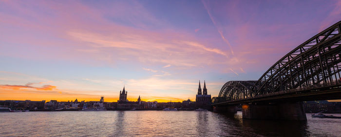 Bridge over river at sunset