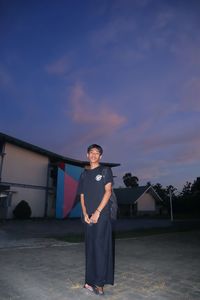 Portrait of young man standing against sky