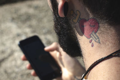 Close-up of man using mobile phone