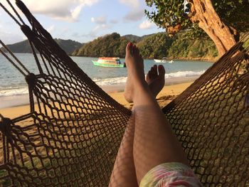 Low section of woman relaxing on beach