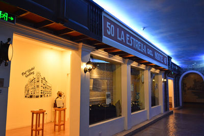 Information sign on illuminated building at night