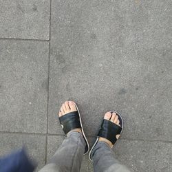 Low section of man standing on footpath