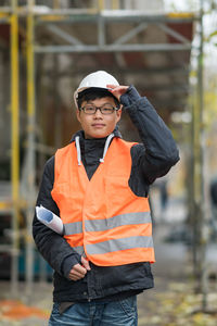 Portrait of engineer in reflective clothing standing outdoors