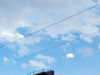 Low angle view of cables against sky