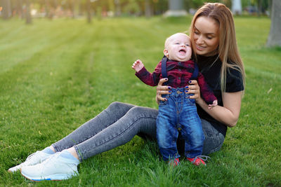 Mother playing with cute son in park