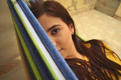 Portrait of young woman resting in hammock