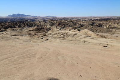 View of desert against clear sky