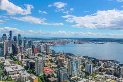 High angle view of city by sea against sky