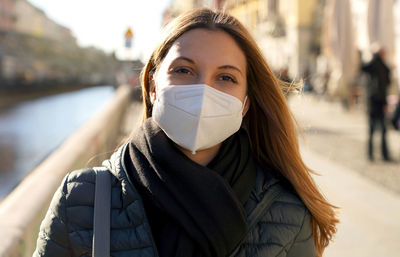 Portrait of woman wearing mask on street