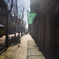 Footpath amidst buildings in city