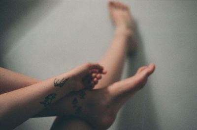 Midsection of woman with shadow on wall