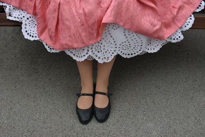 Low section of woman wearing canvas shoes