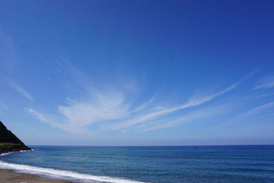 Scenic view of sea against blue sky