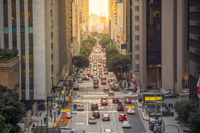 High angle view of traffic on city street amidst buildings