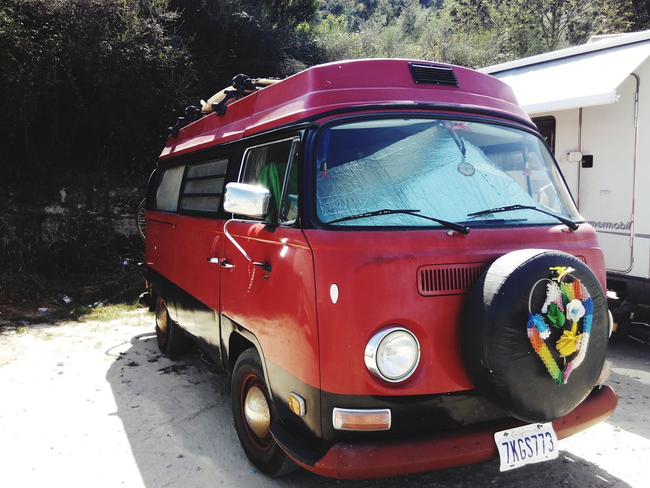 VIEW OF RED CAR PARKED ON ROAD