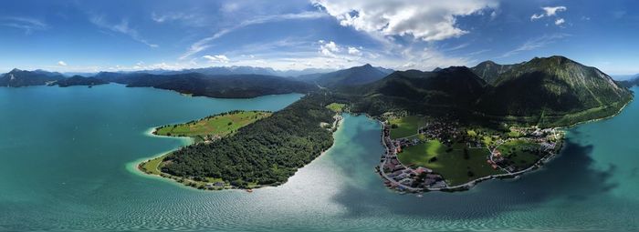 Panoramic view of sea and mountains against sky