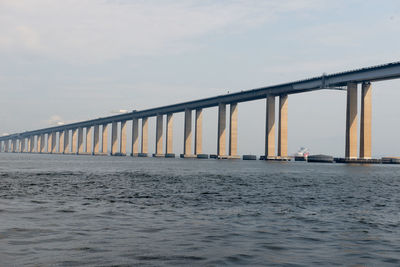 Bridge over sea against sky