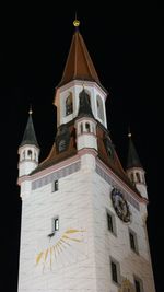 Low angle view of bell tower against sky at night
