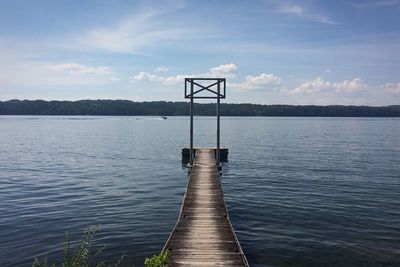 Pier over lake against sky