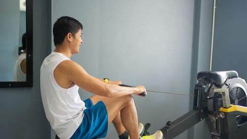 Side view of man exercising at home