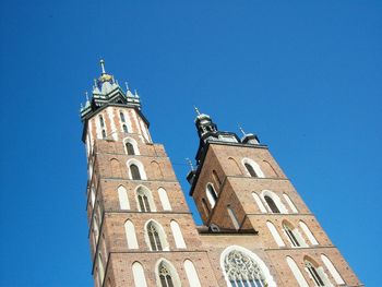 Low angle view of bell tower against blue sky