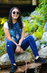 Portrait of smiling young woman sitting outdoors