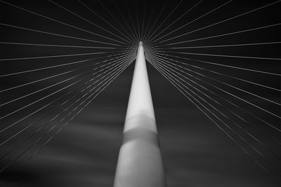 Close-up of suspension bridge against sky