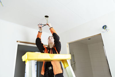 Young woman renovating house