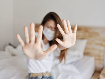 Portrait of woman covering face with hand