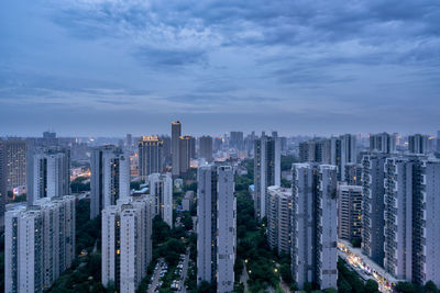 Aerial view of buildings in city against sky