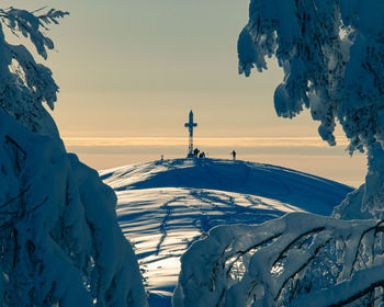 Scenic view of snow covered mountains against sky during sunrise