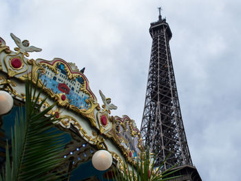 Low angle view of eiffel tower against cloudy sky