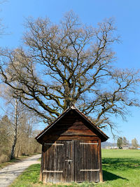 Barn on field against sky