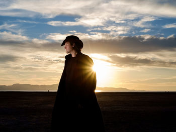 Man standing on landscape against sky